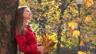 Young woman with autumn leaves