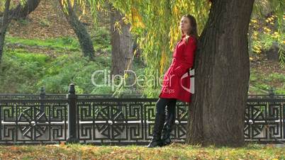 Young woman near tree in park