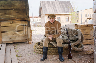 Retro style picture with soldier sitting on the rope