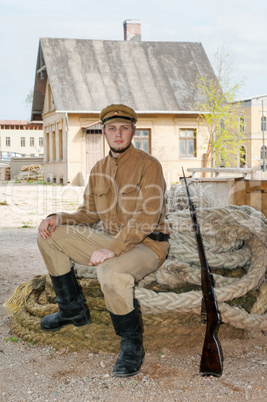 Retro style picture with soldier sitting on the rope