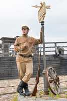 Retro style picture with soldier at tram stop.