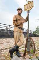 Retro style picture with soldier at tram stop.