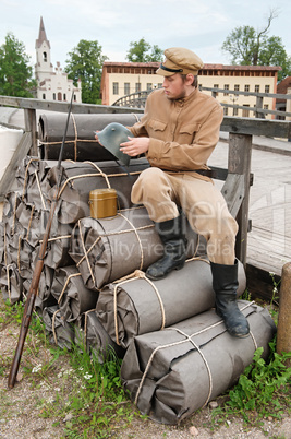 Retro style picture with soldier sitting on the bundles