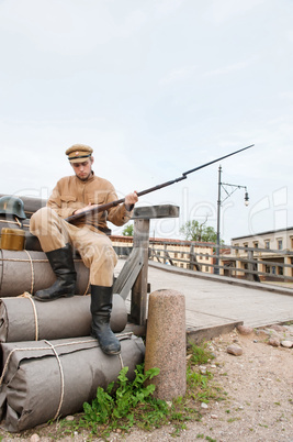 Retro style picture with soldier sitting on the bundles