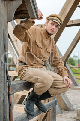 Retro style picture with soldier sitting next to the sentry.