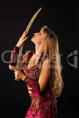 Beauty arabian dancer with saber look on it