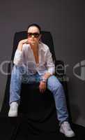 Young beauty woman sit in jeans and open shirt