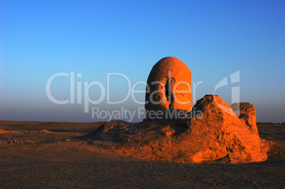 Relics of an ancient castle in the desert at sunrise