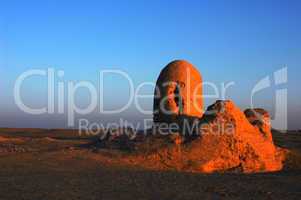 Relics of an ancient castle in the desert at sunrise