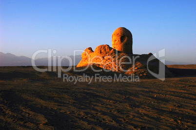 Relics of an ancient castle in the desert at sunrise