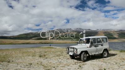 Jeep and fisherman at coastline of Dayan Nuur lake