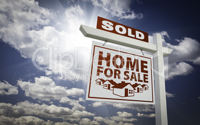 White Sold Home for Sale Real Estate Sign Over Clouds and Sky