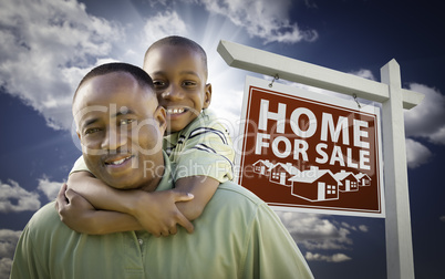 African American Father with Son In Front of Real Estate Sign