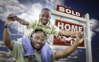 African American Father with Son In Front of Sold Home For Sale