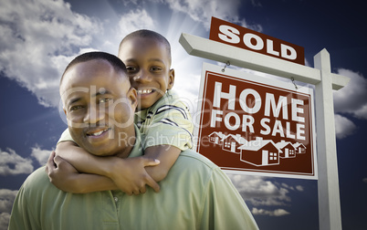 African American Father with Son In Front of Sold Home For Sale