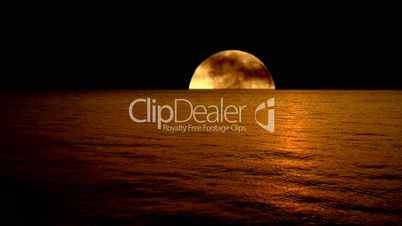 Timelapse amber full moon reflected on slow motion gentle waves