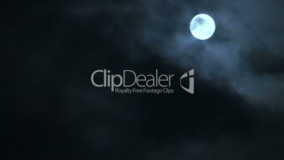 Timelapse clouds flowing past full moon