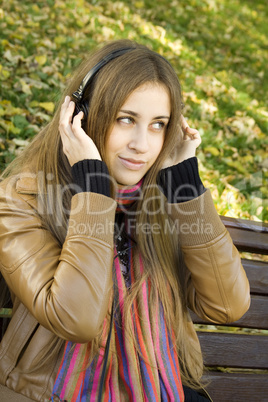 Young woman with headphones in the park