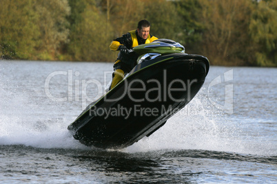 Man Jumping Wet Bike or Jet Ski At Speed