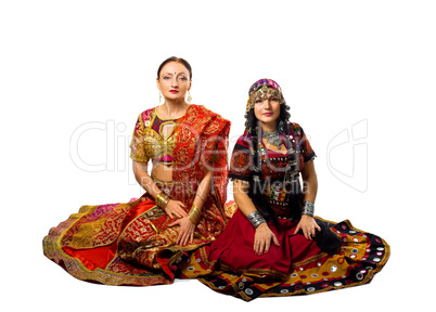 Two woman sit in traditional indian costume