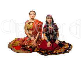 Two woman sit in traditional indian costume