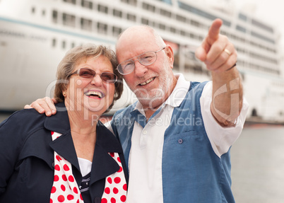 Senior Couple On Shore in Front of Cruise Ship