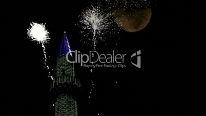 Fireworks and full moon over Mosque minaret