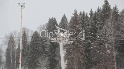 Skiing lift under snowfall