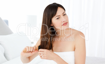 Beautiful woman brushing her hair