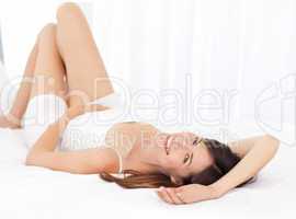 Pretty woman lying down on her bed