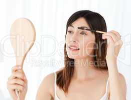 Beautiful woman putting on Make up