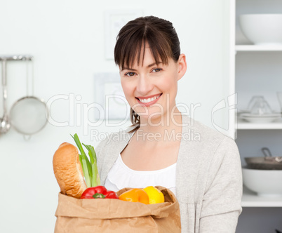 Woman with shoping bags in the kitchen