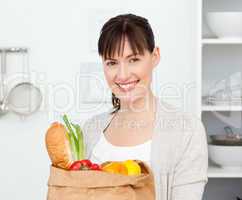 Woman with shoping bags in the kitchen