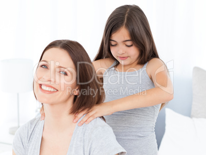 Lovely daughter brushing her woman hairs at home