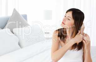 Beautiful woman brushing her hair