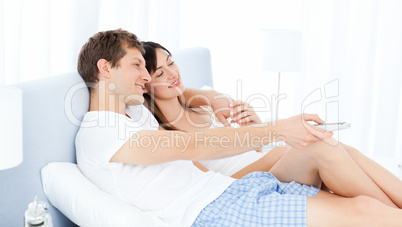 Smiling couple watching tv at home