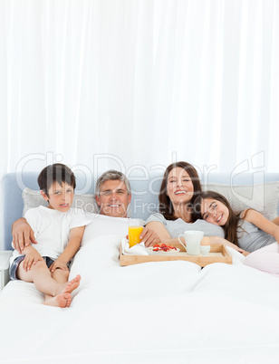 Family having breakfast in their bed