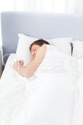 Man sleeping in his bed at home