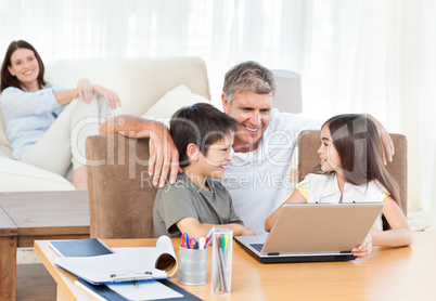 Family looking at the laptop