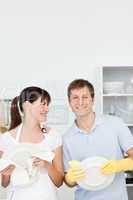 Lovers washing dishes together