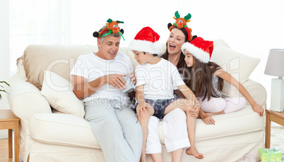 Family during Christmas day looking at their presents