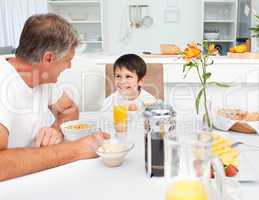 Father having his breakfast with his son