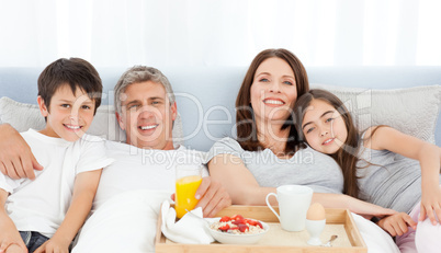 Family having breakfast in their bed
