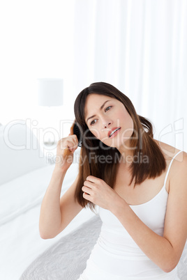 Beautiful woman brushing her hair