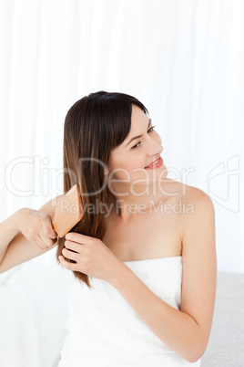 Beautiful woman brushing her hair