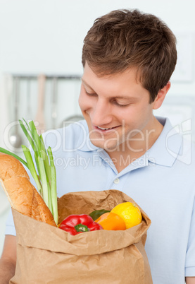 Man with shoping bags in the kitchen