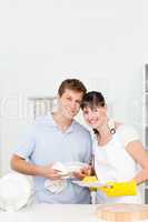 Couple washing dishes together