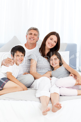 Family  lying down on their bed