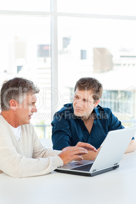 Two businessman working on their laptop