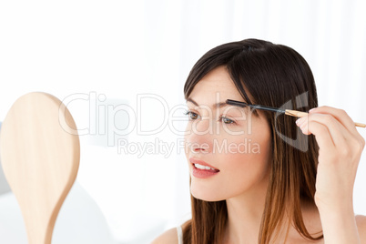 Beautiful woman putting on Make up